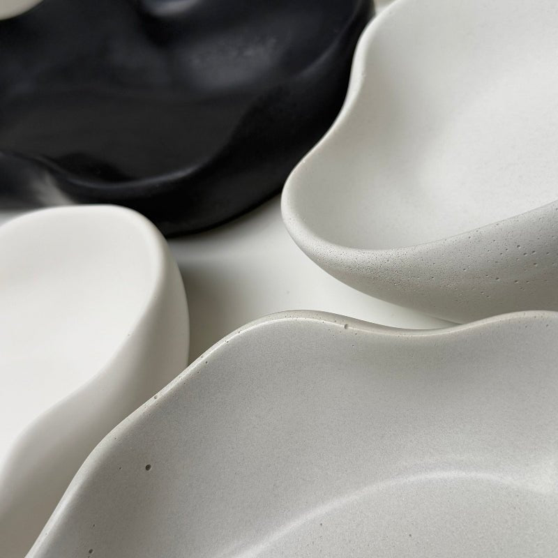 Close-up of black and white ceramic bowls with a textured surface.