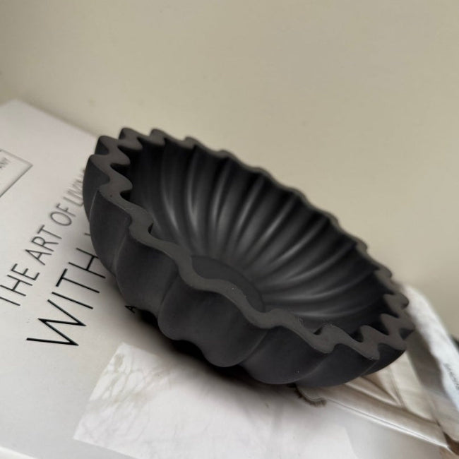 Black stone decorative bowl on a book with text