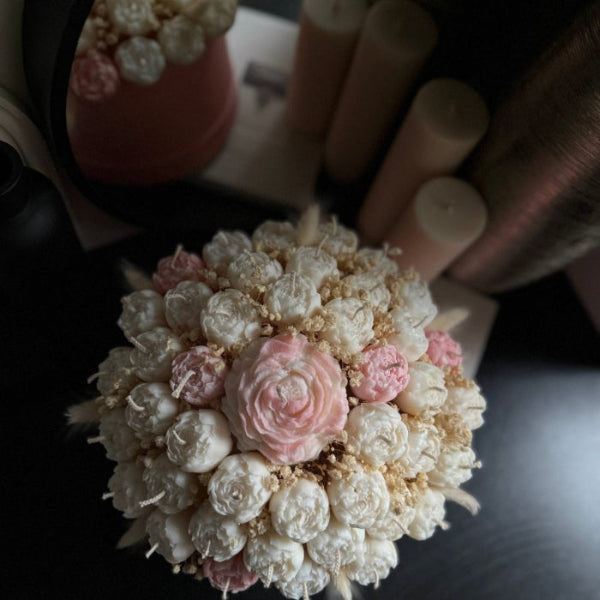 Decorative flower arrangement with pink and white flowers.