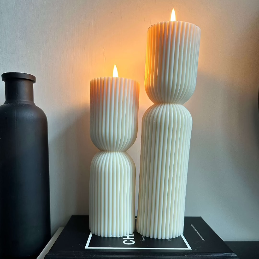 Ribbed sculpture Soy wax pillar candle set emitting a delicate flame