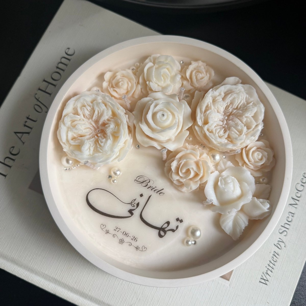 Decorative Candle with white floral designs and 'Bride' text on a black background