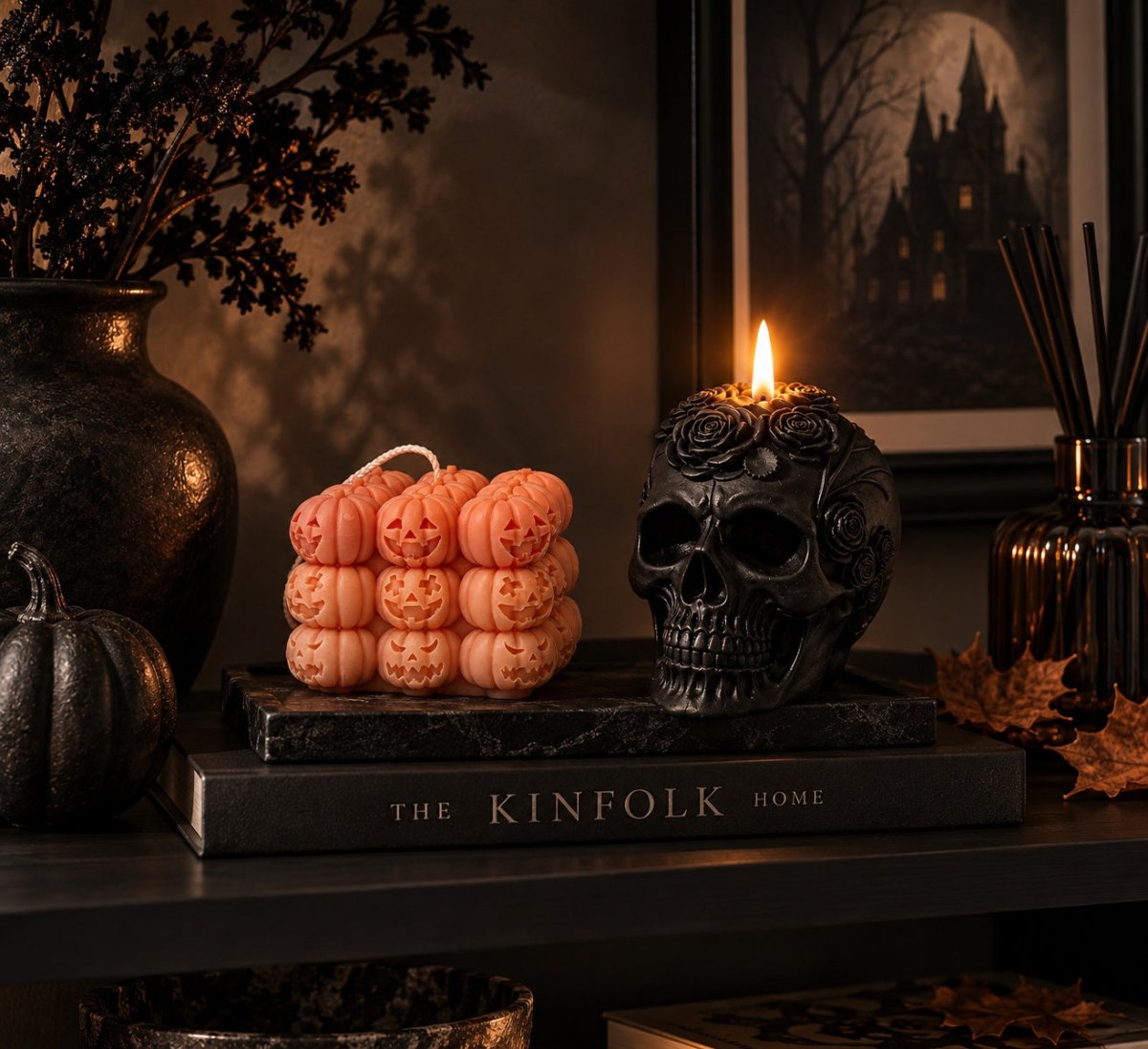     Orange pumpkin candle styled with black floral skull candle for Halloween
