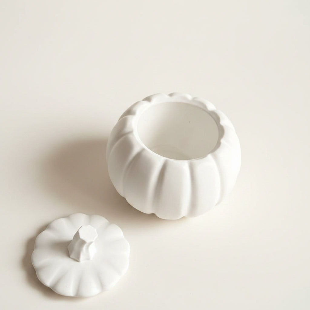 A white stone pumpkin-shaped container with a matching lid, shown open on a plain off-white background.
