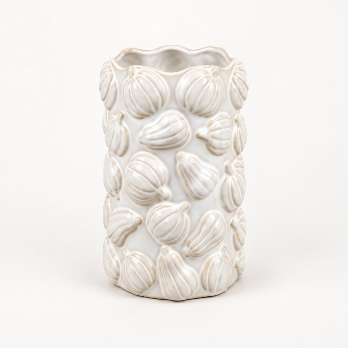 A white ceramic cylindrical vase with a textured, raised pumpkin pattern and a scalloped rim, shown on a clean white background.
