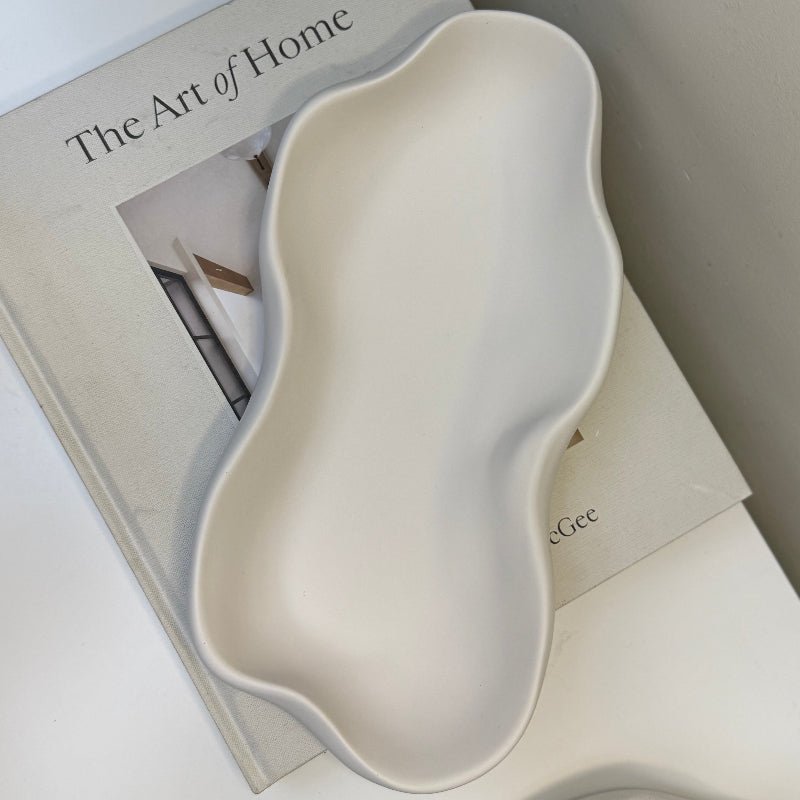 White dish  on a magazine titled 'The Art of Home'