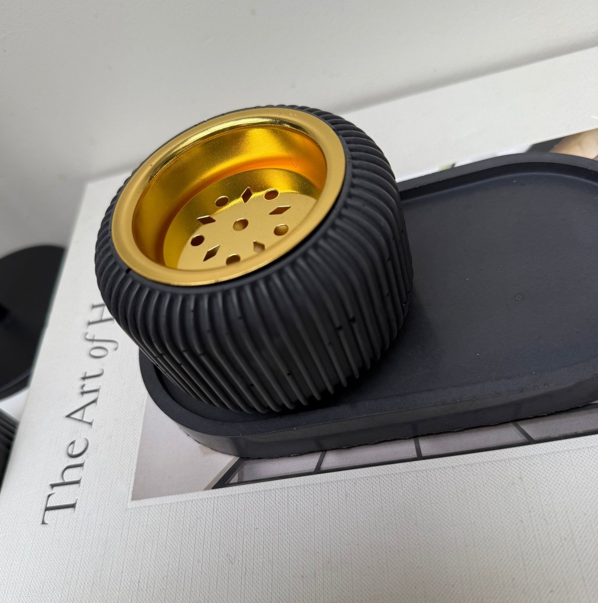 Modern Stone Bakhoor Incense Burner on display with ribbed black design and gold-tone removable plate.