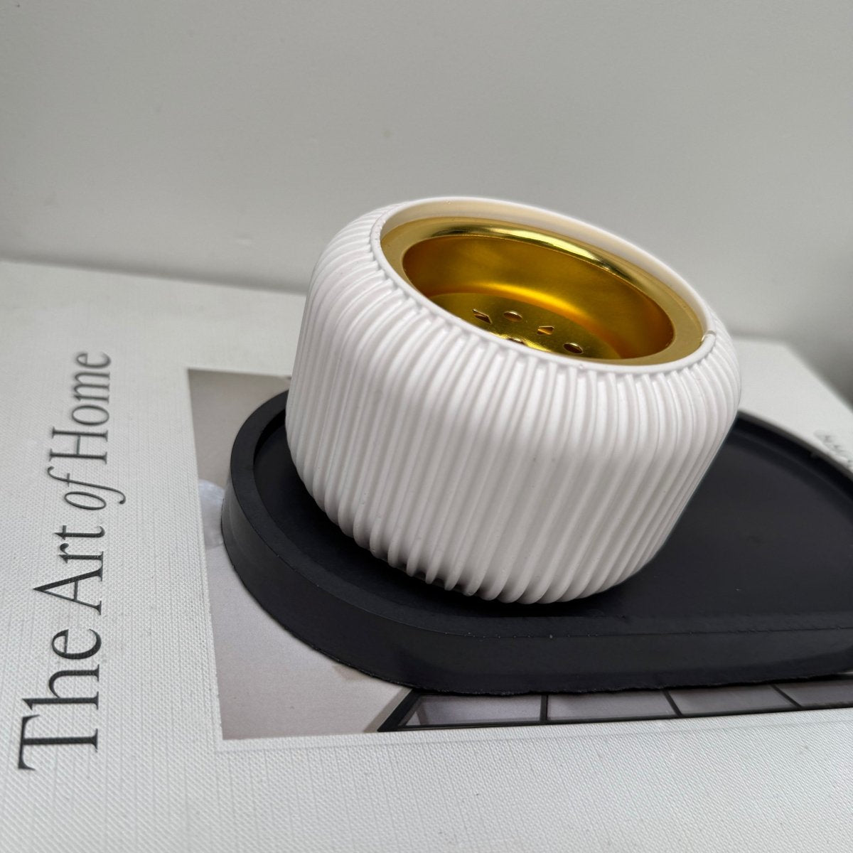 Modern Stone Bakhoor Incense Burner with ribbed design in white and gold-tone removable plate on a sleek black tray.