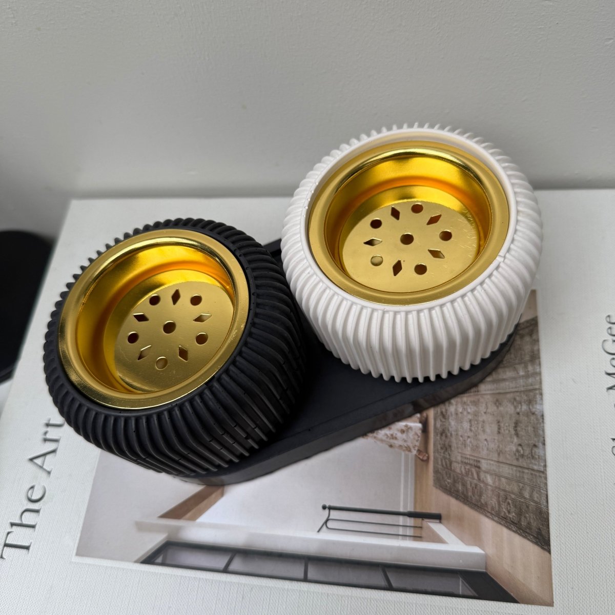 Modern stone bakhoor incense burner in charcoal black and crisp white with gold-tone removable plates.