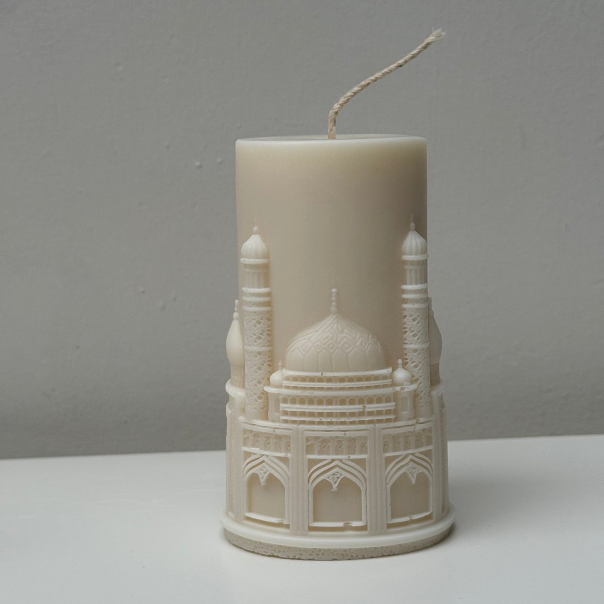 Decorative candle with intricate design on a plain background