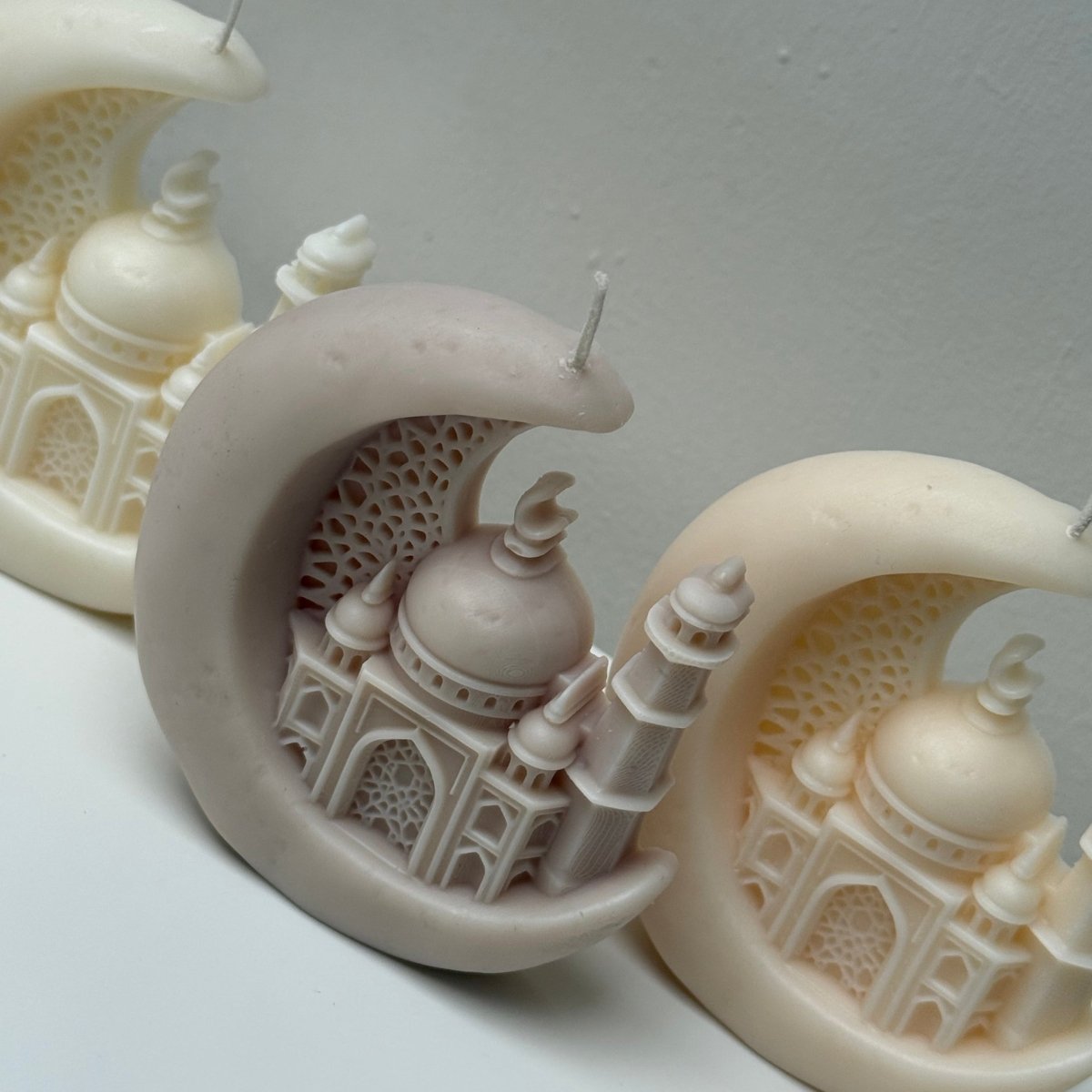 Decorative Candles resembling a mosque on a crescent moon against a gray background