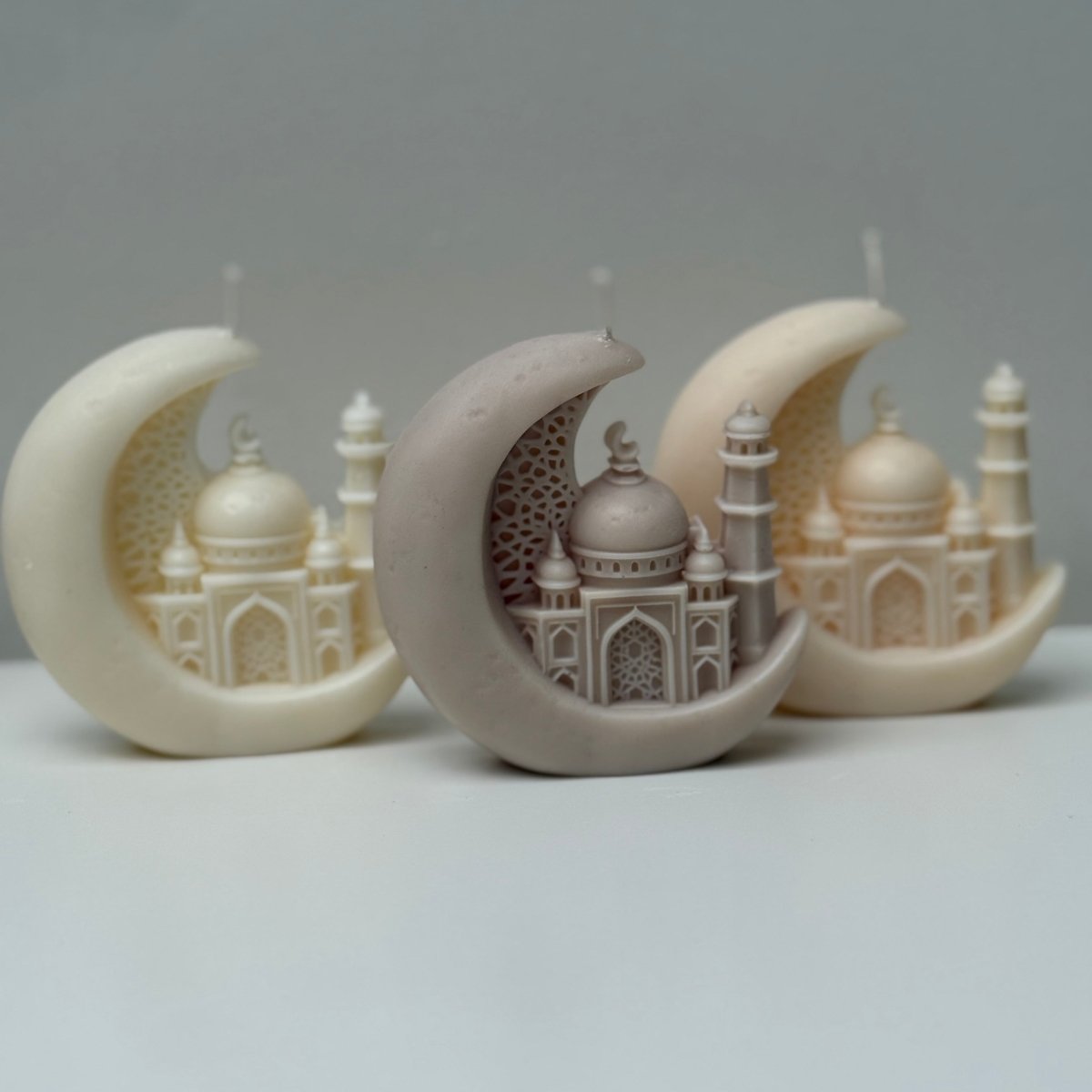 Decorative Candles resembling a mosque on a crescent moon against a gray background