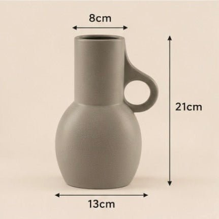 A grey ceramic pitcher with a cylindrical neck, a loop handle, and a rounded base, shown with dimension arrows and labels indicating 8cm width at the top, 13cm base width, and 21cm height.
