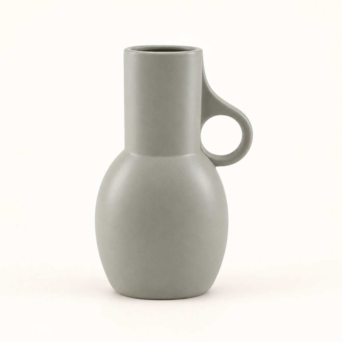 A matte grey ceramic pitcher vase with a bulbous base, a short cylindrical neck, and a loop handle on the right side, shown on a clean white background.