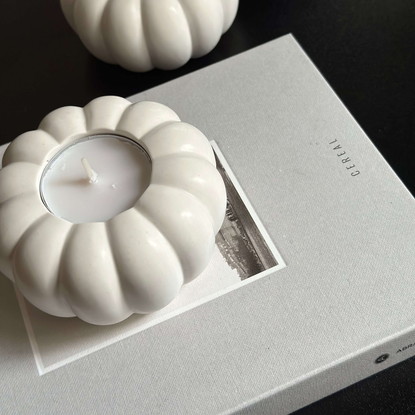 Stone pumpkin candle holder used as autumn table centrepiece decor