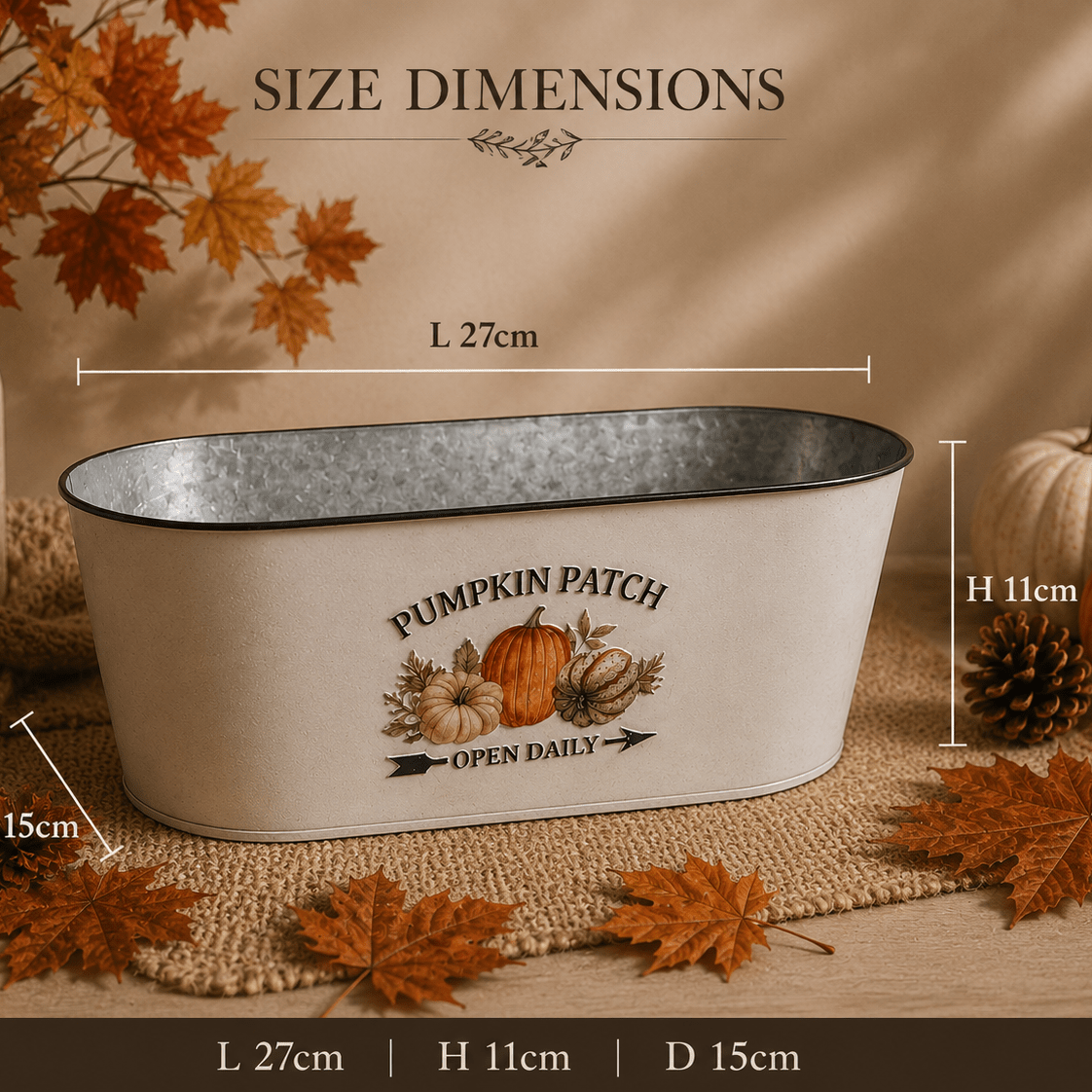 Zinc metal planter with a cream-colored exterior and a rustic 'Pumpkin Patch' graphic, shown with overlaid dimension lines indicating its size (L 27cm, H 11cm, D 15cm) against a warm autumn-themed background.