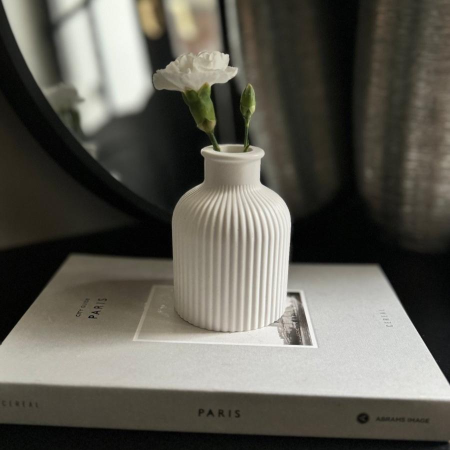 SORA Stone Vase styled on a minimalist living room coffee table.