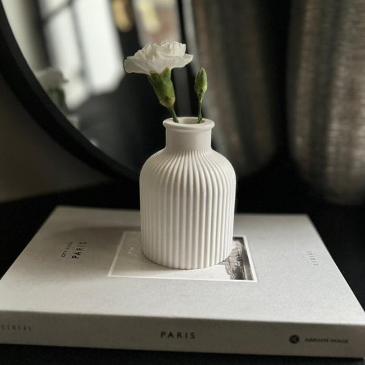SORA Stone Vase styled on a minimalist living room coffee table.