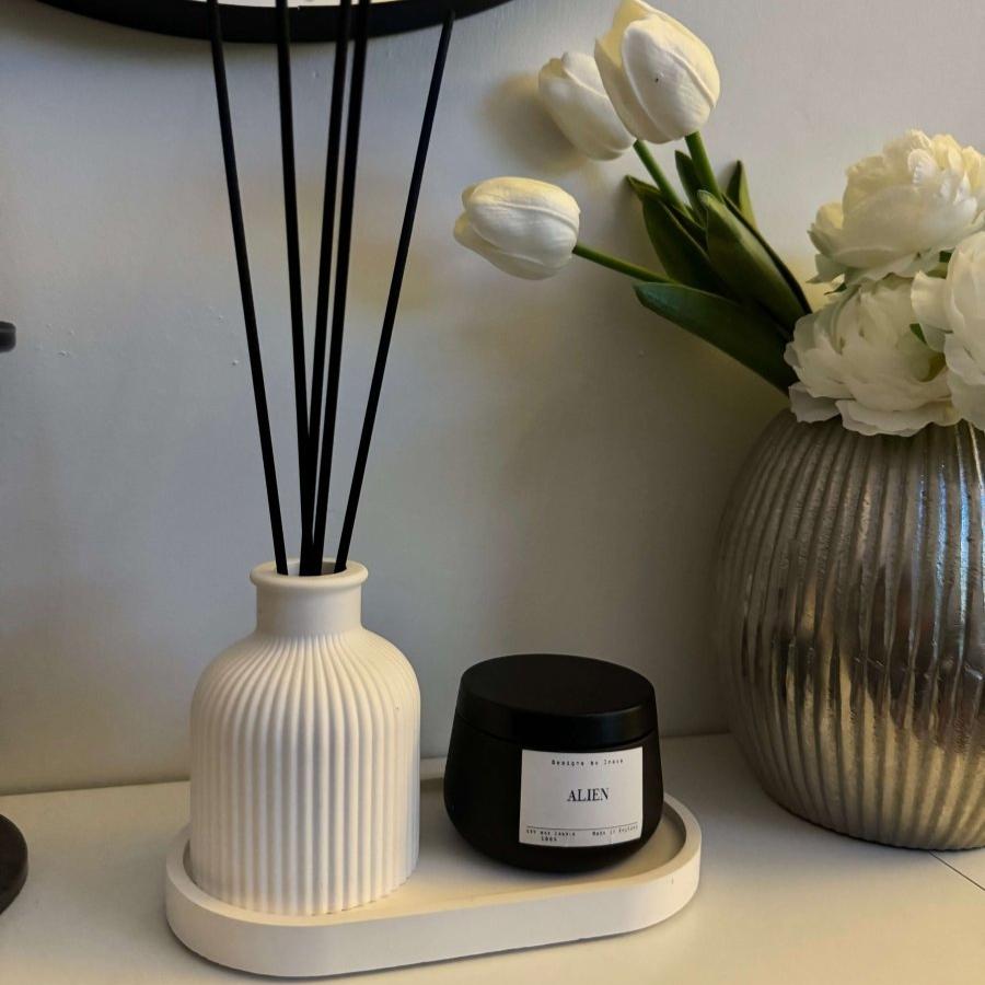 SORA Stone Vase styled on a minimalist console table with decorative flowers.