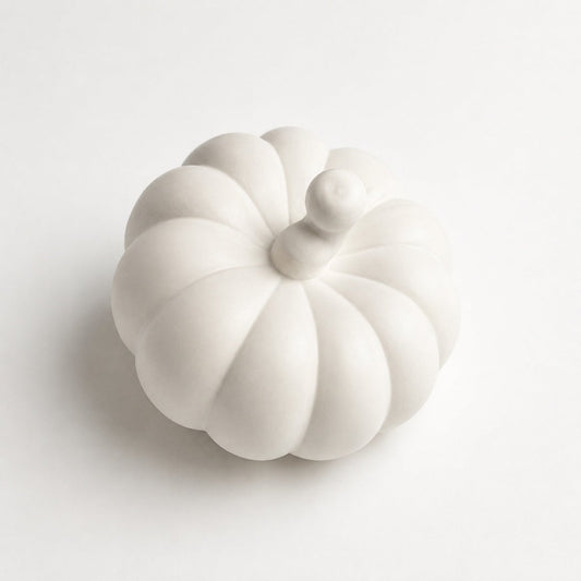 A white Stone pumpkin-shaped ornament, photographed on a clean white background.
