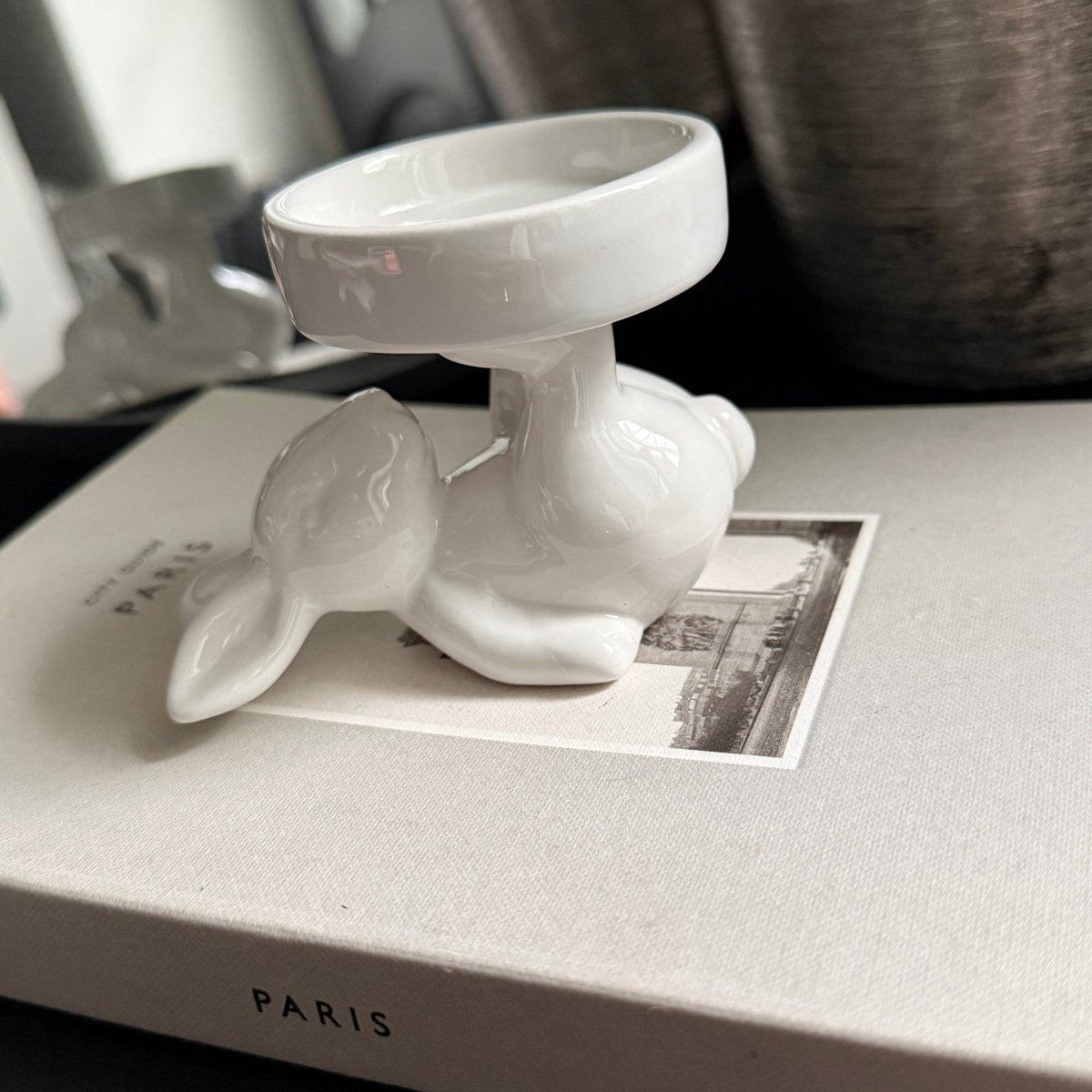 white ceramic rabbit candle holder -Close-up of a decorative candle holder with a rabbit design
