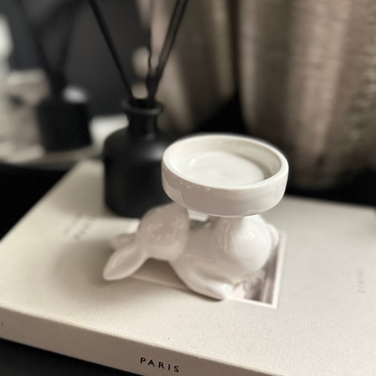 white ceramic rabbit candle holder - White rabbit-shaped candle holder on a white surface with 'PARIS' text