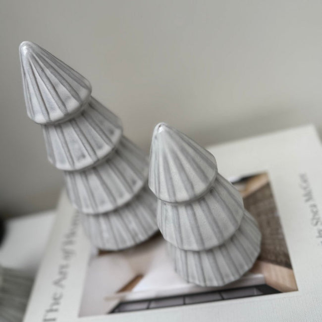 Decorative gray Christmas trees on a book with a blurred background